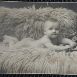 Fotografie tip Carte Postala, Bebelus nud, intins pa o blana, 1924