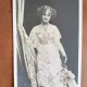 Fotografie tip carte postala, femeie cu flori, inceput de secol XX