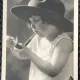 Fotografie tip Carte Postala, Fetita aprinzand o pipa, perioada interbelica